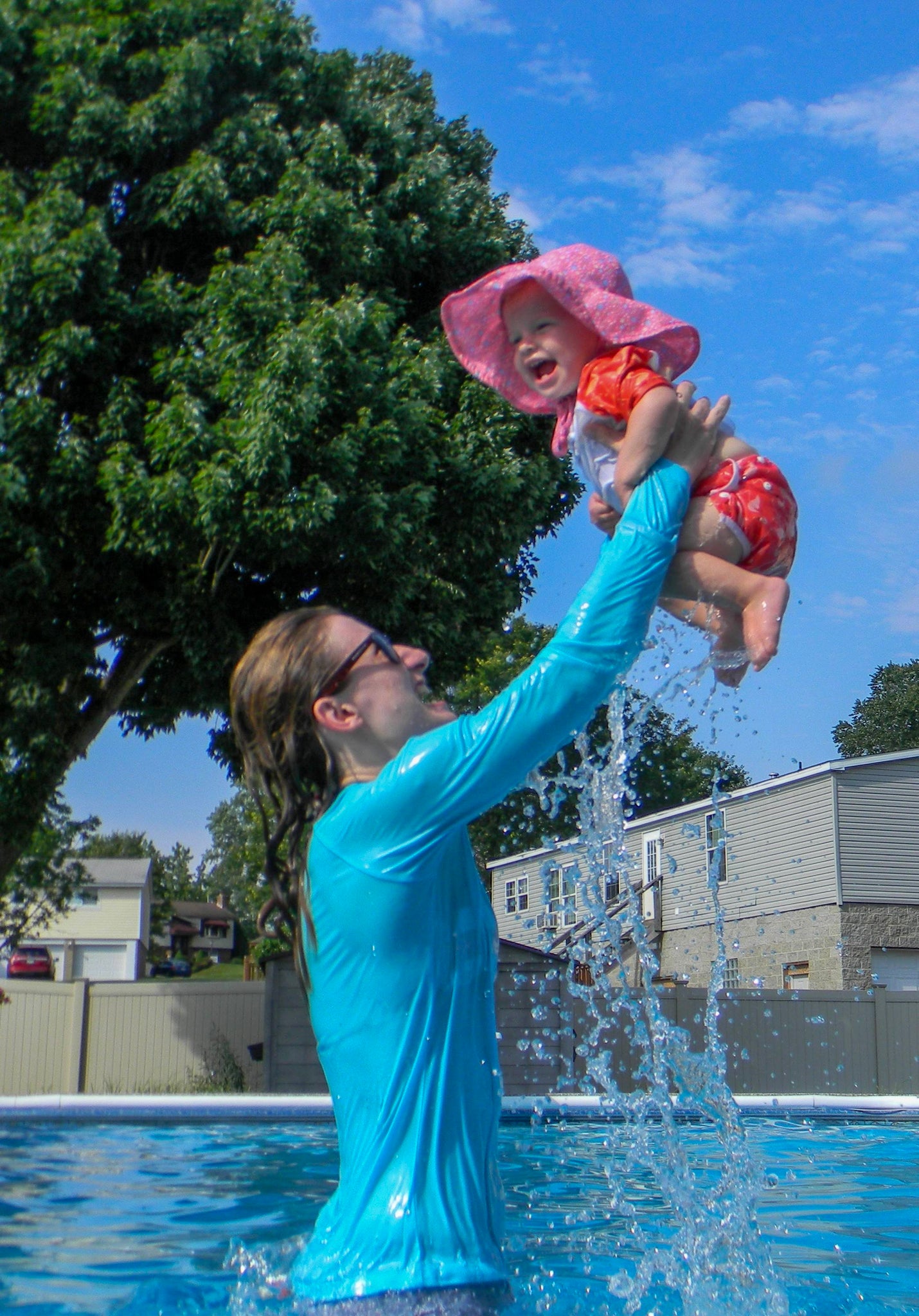 Joyful mother bonding with baby in pool