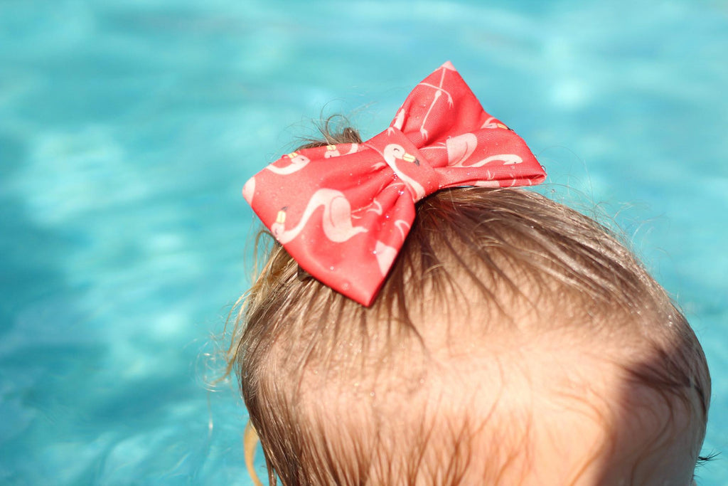 Flamingo bow worn by a child