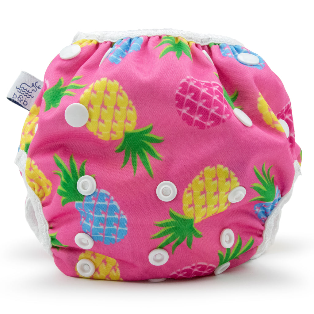 Beau and Belle Littles Swim Diaper, Regular Size, light pink background with yellow, dark pink, and blue pineapples, front view
