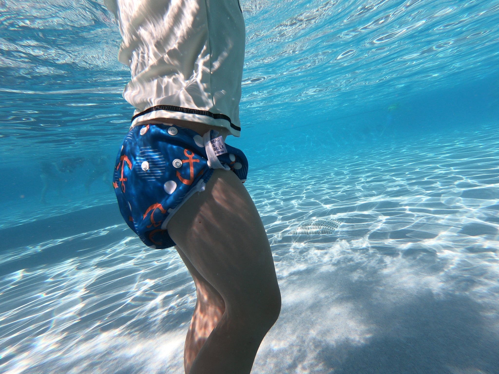 underwater picture of toddler wearing Beau and Belle Littles Swim Diaper, Large Size, Anchor print