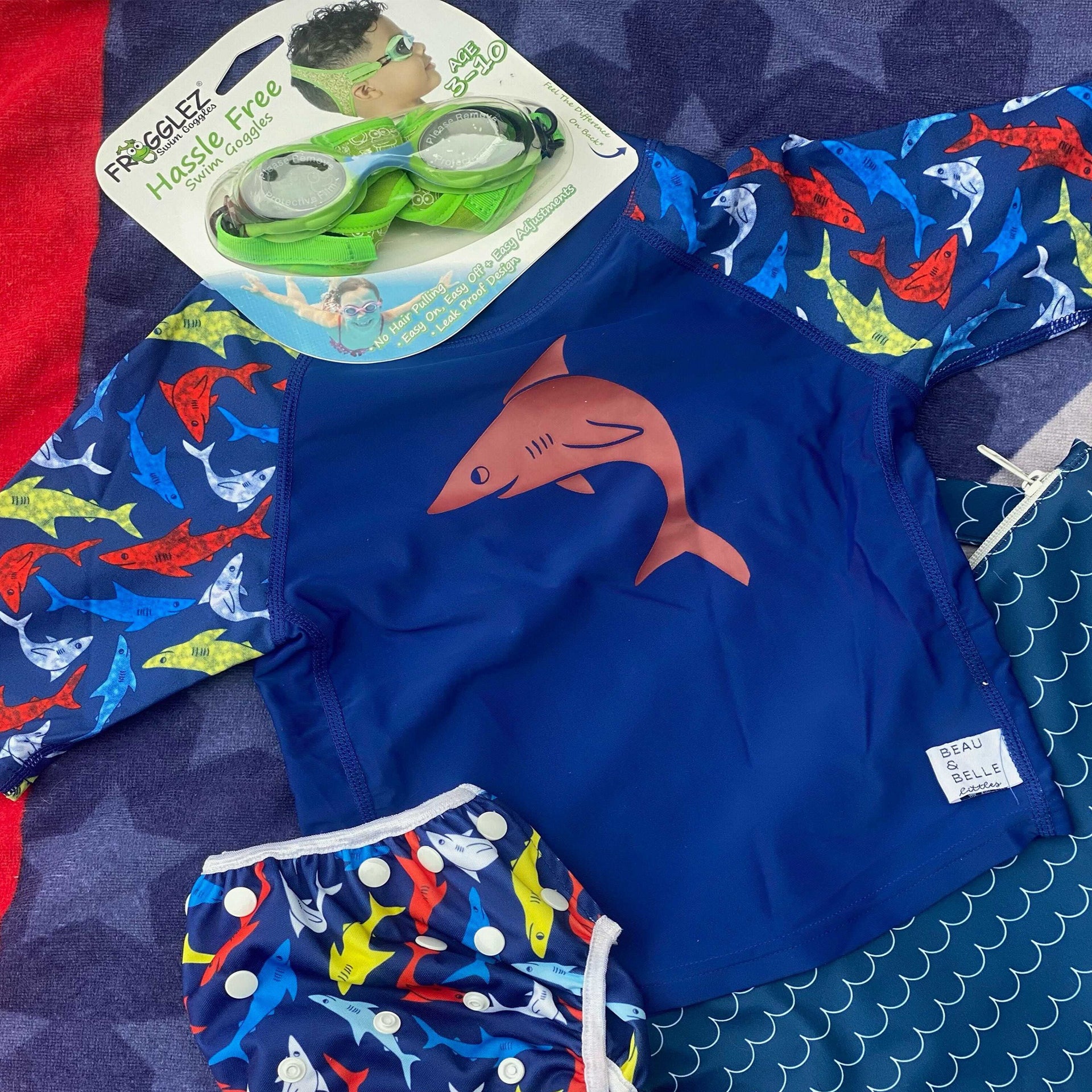 Swimming starter kit for boys with frogglez goggles, shark rash guard, reusable swim diaper.