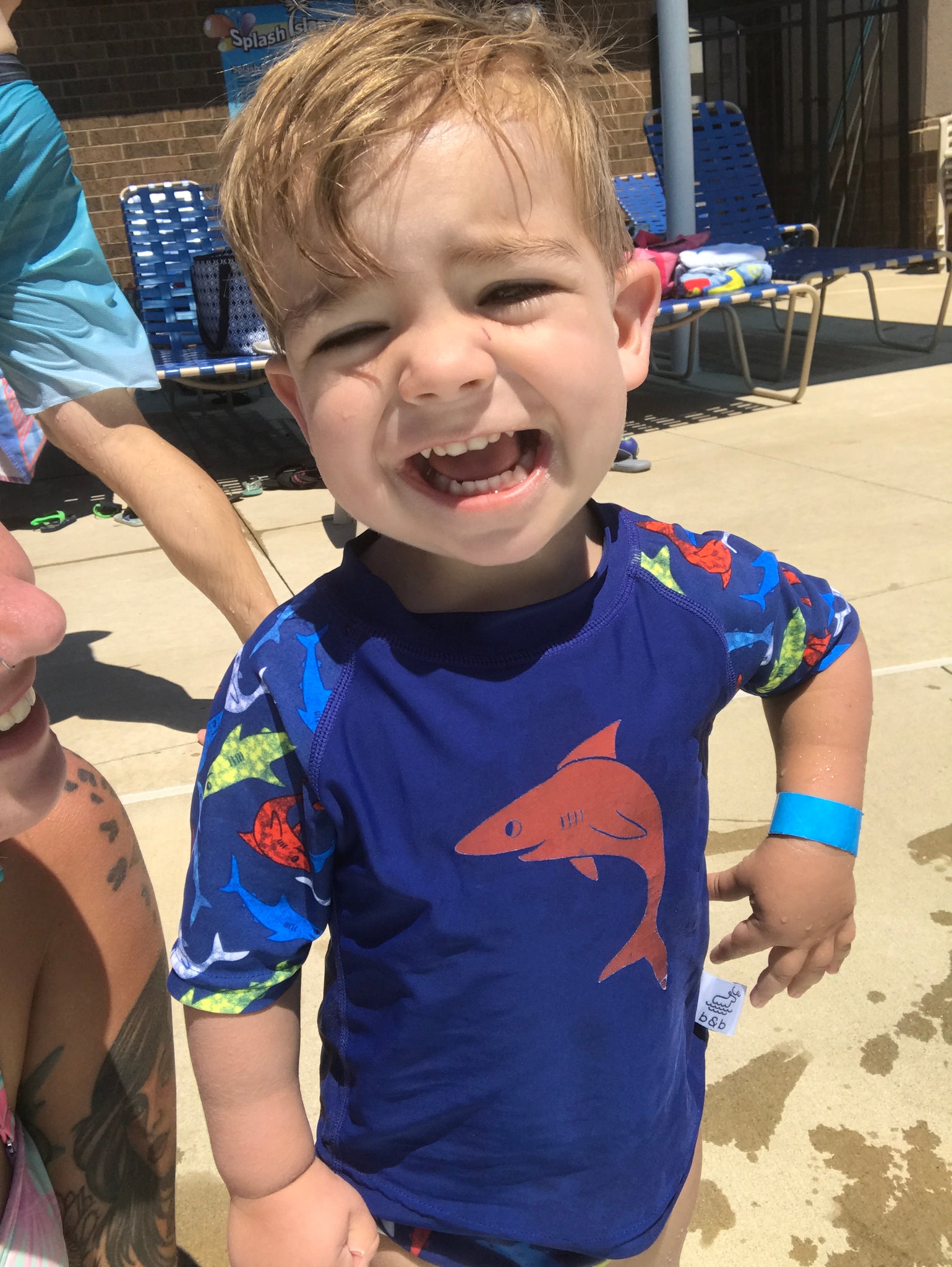 boy wearing a Beau and Belle Littles Rash Guard/Swim Shirt, dark blue with lighter blue 3/4 sleeves, shark print