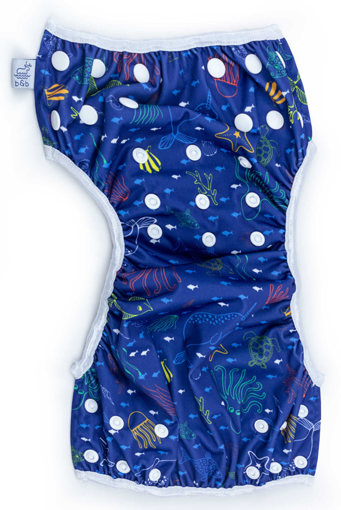 Beau and Belle Littles Swim Diaper, Regular Size, dark blue with outlines of sea creatures, Sea Friends print, unbuttoned and laid flat