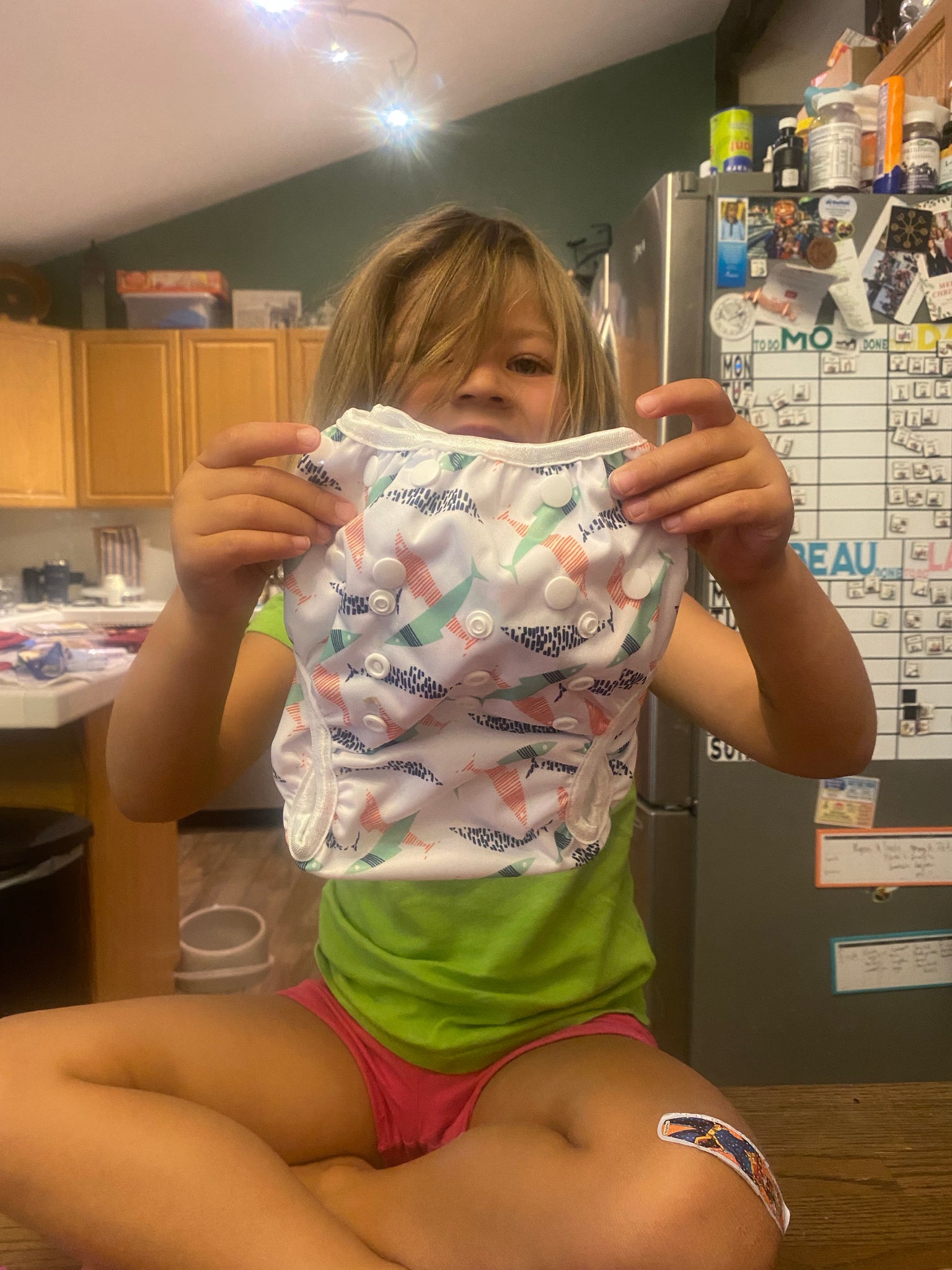 Baby holding reusable swim diaper
